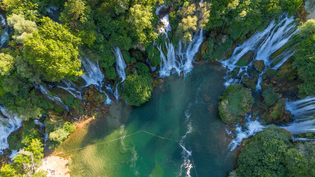 Aerial top down view of majestic Kravica waterfall cascades and emerald pool in Bosnia and Herzegovina