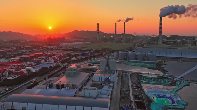 Industrial port area large shipping cargo containers sunset. Fossil fuel power plant air smoke stacks, wind turbine. Global logistics trade industry terminal. Windmill energy factory. Smoking chimneys
