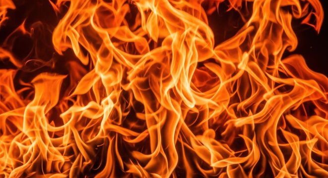 Intense fiery flames dancing in a dark background