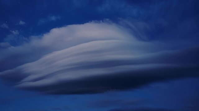 Timelapse of Rare Lenticular Cloud Formation Moving Over Deep Blue Night Sky