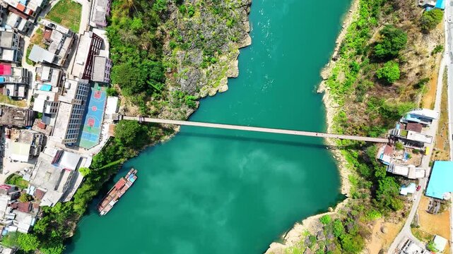 Mid-Altitude Aerial of Suspension Footbridge Over Swift River in Karst Canyon, Scattered Homes