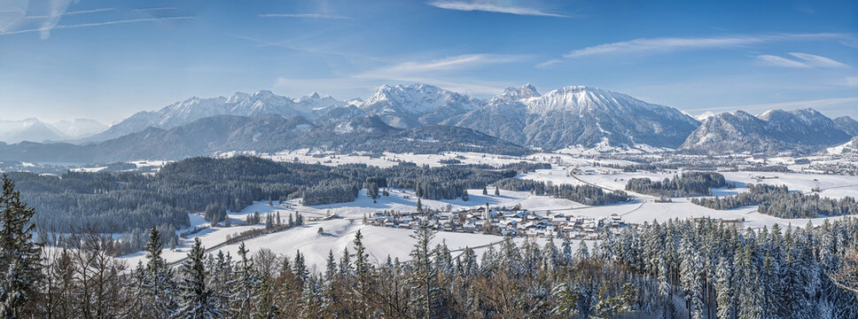 Beautiful Allgaeu Winter Panorama of Zell near Pfronten and Eisenberg Castle, Scenic Alpine Mountain Range with Idyllic Snowy Village at Sunny Day, Majestic Wilderness Landscape Banner Background