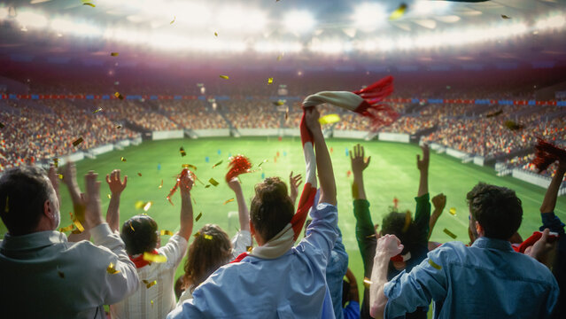 Golden Confetti Falling Over Diverse Excited Fans Waving a Red Scarf and Raising Hands to Cheer Their Winning Team During a Soccer Championship, Happy Crowd Celebrating Victory at a Football Stadium.