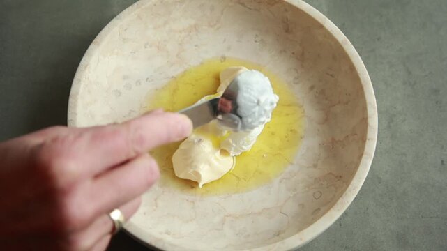 Close-up of whisking a creamy and zesty Mexican-inspired hot salad dressing with spices in a ceramic bowl