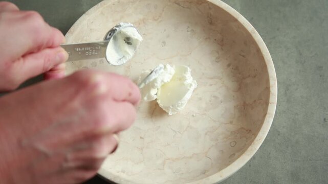 Close-up of whisking a creamy and zesty Mexican-inspired hot salad dressing with spices in a ceramic bowl