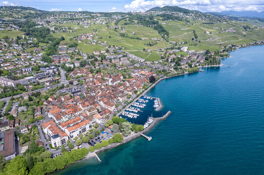 Aerial view of the historic town of Lutry featuring its harbor and terraced vineyards on the shores of Lake Geneva, Lutry, Vaud, Switzerland.