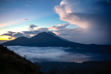 Fototapeta premium Mount Batur and Lake Batur at Sunrise with Sea of Clouds