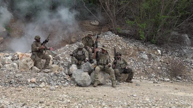 Military training exercise with soldiers in formation during a smoke drill in an outdoor location