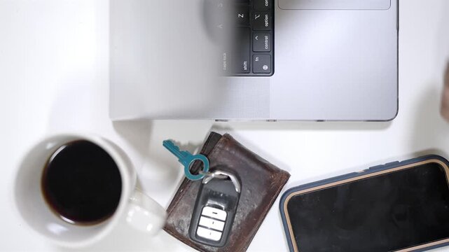 Top down view of a digital nomad remote work setup with laptop, coffee