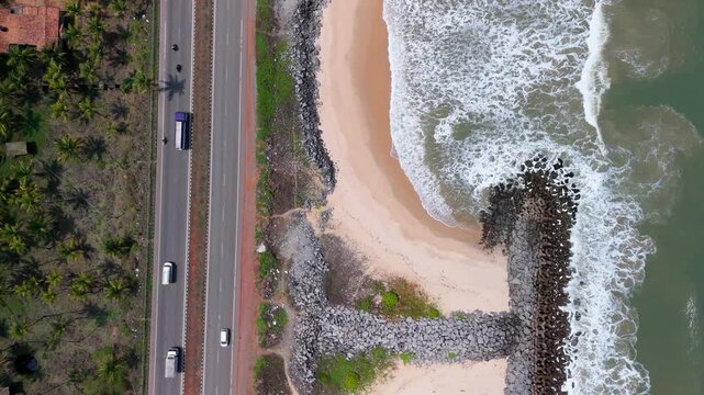 Scenic Aerial View of NH 66 Coastal Highway Running Along Seaside Landscape with Moving Traffic, Ocean Views, Modern Road Infrastructure, Beautiful Shoreline and Long Distance Transportation Route