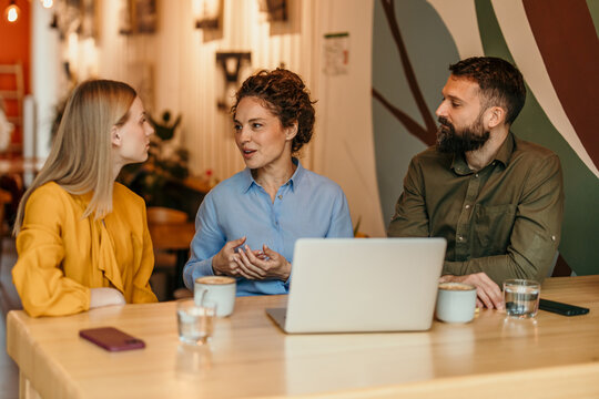 Business colleagues collaborating during a casual cafe meeting