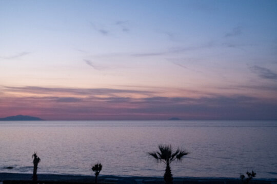 Sunset over the Mediterranean Sea along the Sicilian coast in the village of Venetico, in the province of Messina