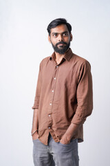 Fototapeta premium Young indian man standing confidently on white background