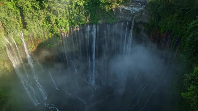 Aerial view of Panorama Tumpak Sewu Waterfalls also known as Coban Sewu.Beautiful rainbow and fog,Tumpak Sewu Waterfalls are a tourist attraction in East Java, Indonesia.Amazing travel destination
