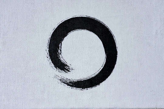 Minimalist zen enso circle brush stroke on white canvas