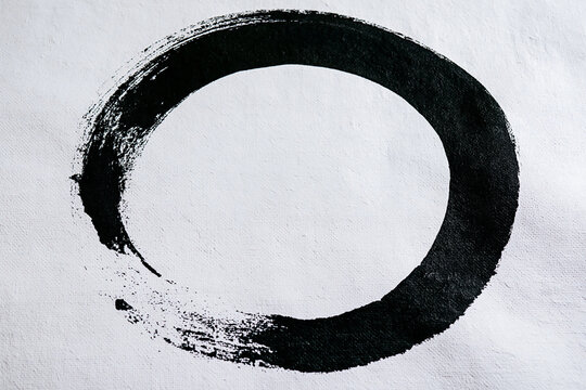 Zen enso circle brush stroke painting on white canvas background