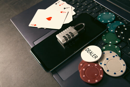 Laptop with a lock and poker chips. Online gambling concept.