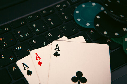 Poker chips and cards on the laptop keyboard. Online casino concept