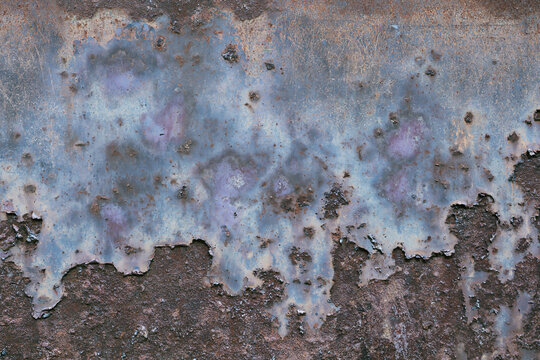 Peeling paint and heavy rust on old metal wall