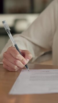 Creative, signature and hand with contract in home, remote work and approve exclusive author rights. Freelance, writer and person with legal document in house, writing and commission approval on desk
