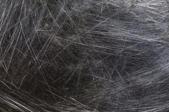 Scratched metallic surface with heavy wear and tear