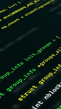 Macro close up vertical view of scrolling green and red programming source code on digital screen for software engineering.
