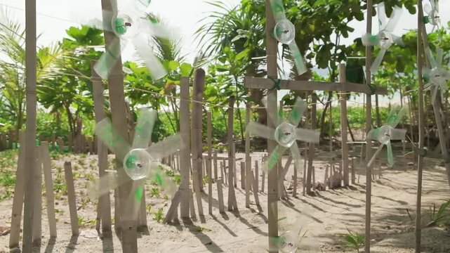 decorative propellers made of plastic bottles rotate in the wind, slow motion
