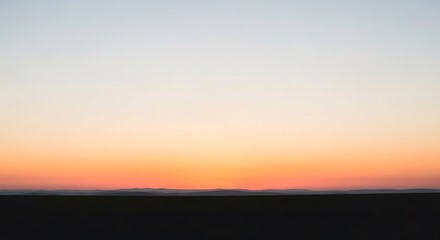 Fototapeta premium Soft pastel sky gradient during twilight hours with subtle cloud formations near the horizon.