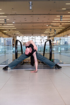 Young man dancer posing in the shopping mall indoor