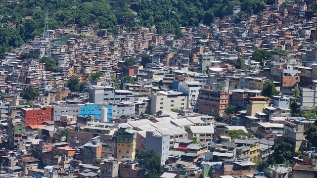 Panorama of Rocinha favela in Rio de Janeiro, Brazil, showcasing a vast cluster of hillside residences framed by lush tropical mountains and the city's iconic landscape