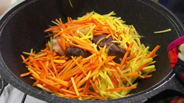 Close-Up of Kazan with Oil Frying Carrots, Onions and Meat