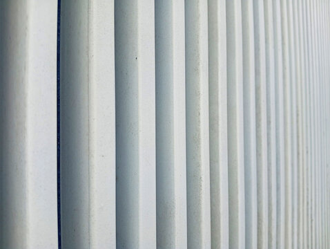 Parallel vertical pillars creating architectural texture with architecture building geometric abstract structure