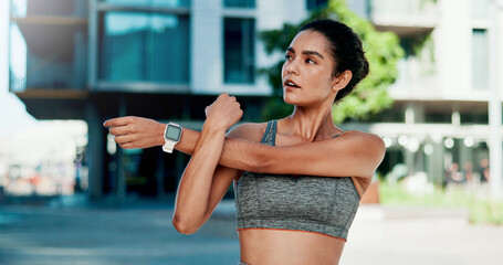 Stretching, thinking and woman in city for fitness, health and mobility to prepare for exercise. Runner, sports and person with warm up for wellness, injury prevention and arm muscle for active hobby © peopleimages.com