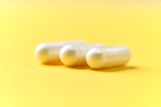 Zinc capsules on bright paper background. Soft focus. Close up. Copy space.