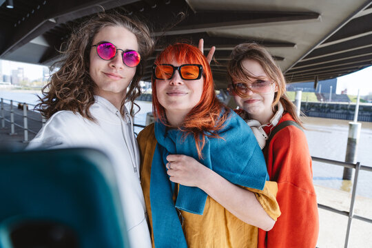 Family taking a fun selfie outdoors wearing sunglasses