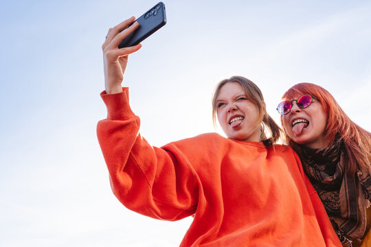 Family taking a funny selfie outdoors in a playful mood
