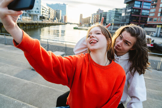 Carefree youth taking a fun selfie outdoors in HafenCity