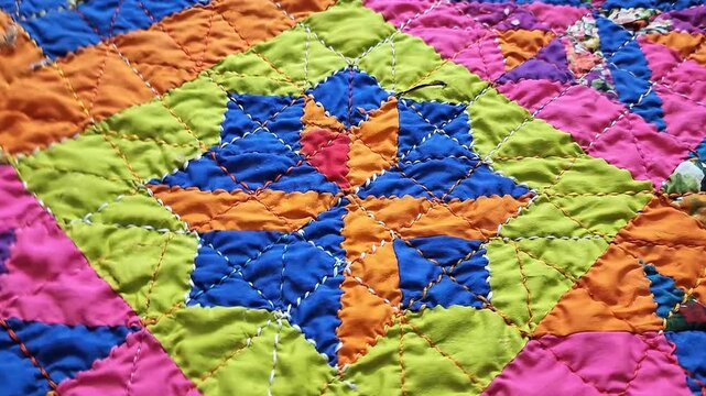 Colorful Handmade Quilt with Geometric Patchwork Pattern and Visible Stitching