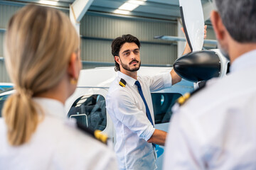 Pilot instructor explaining airplane propeller maintenance to students © unai