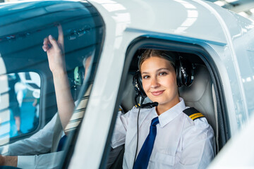 Female pilot smiling wearing headset inside cockpit © unai