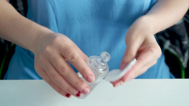 Woman removing red nail polish during personal grooming routine