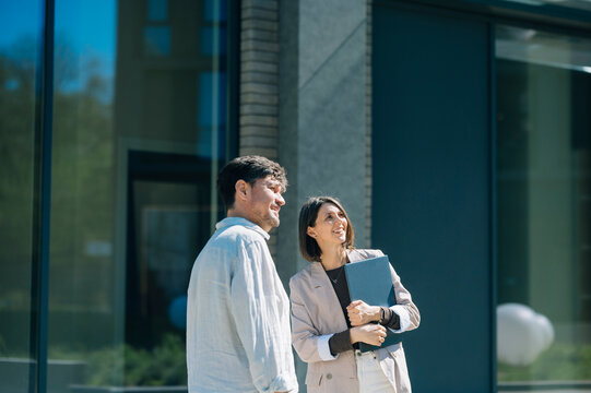 Smiling business colleague outside modern office building