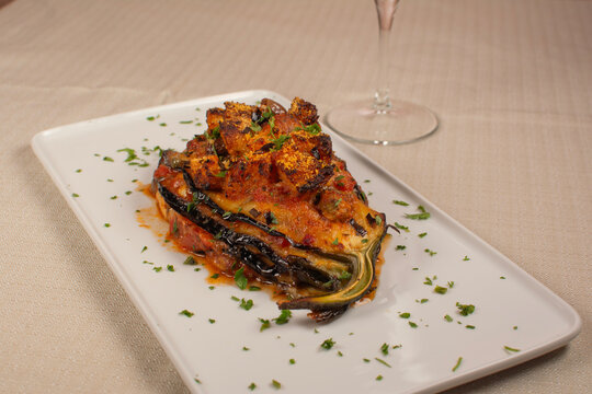 Baked Eggplant Parmesan with Tomato Sauce on White Plate