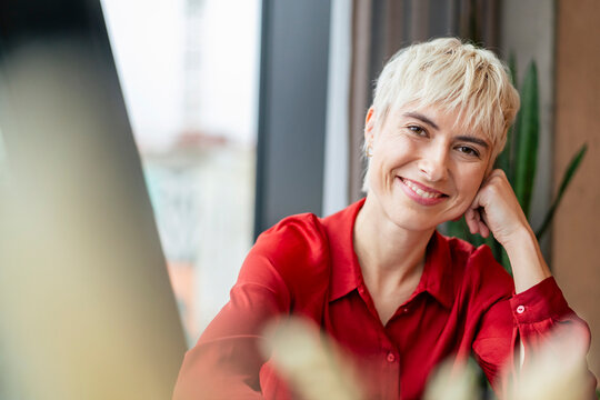 Smiling manager sitting at a desk in an office