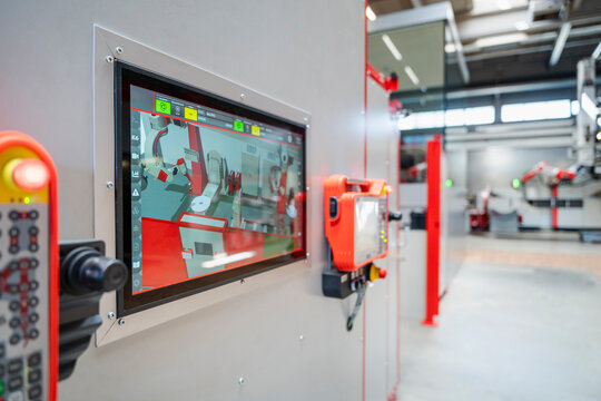 Control panel screen showing automated industrial robot in factory