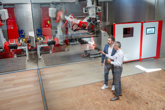Colleagues discussing automation technology in a modern factory