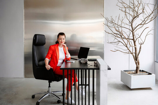 Confident entrepreneur sit at modern office desk with laptop