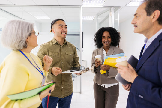 Engineering team talking and smiling during an office meeting