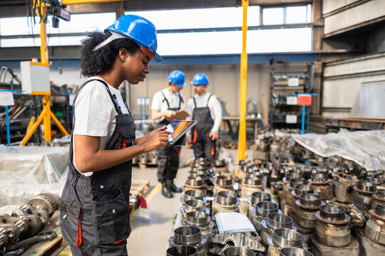 Supervisor uses digital tablet in manufacturing facility