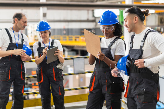 Team of engineers discussing maintenance indoors